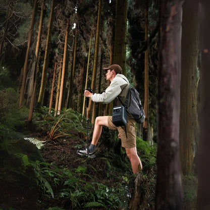Anker SOLIX C300X Portable Power Station wit a man carrying in the forest