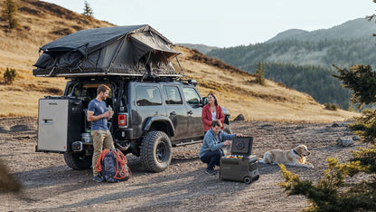 Anker SOLIX EverFrost 2 Electric Cooler 40L beside a camping van with three people