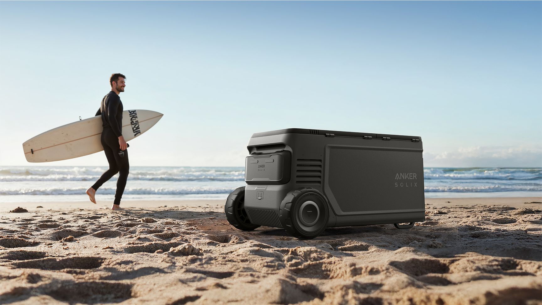 Anker SOLIX EverFrost 2 Electric Cooler 58L beside a man holding a surfboard