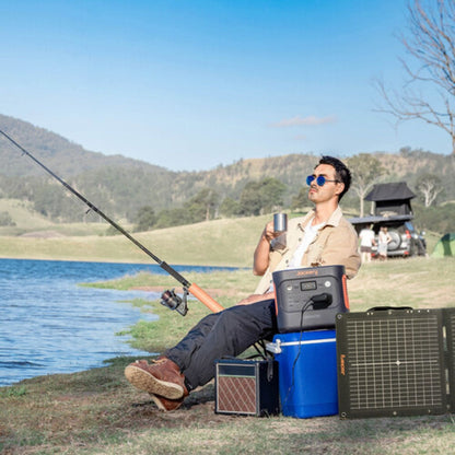 Jackery Explorer 2000 v2 Portable Power Station with solar panel next to a man fishing