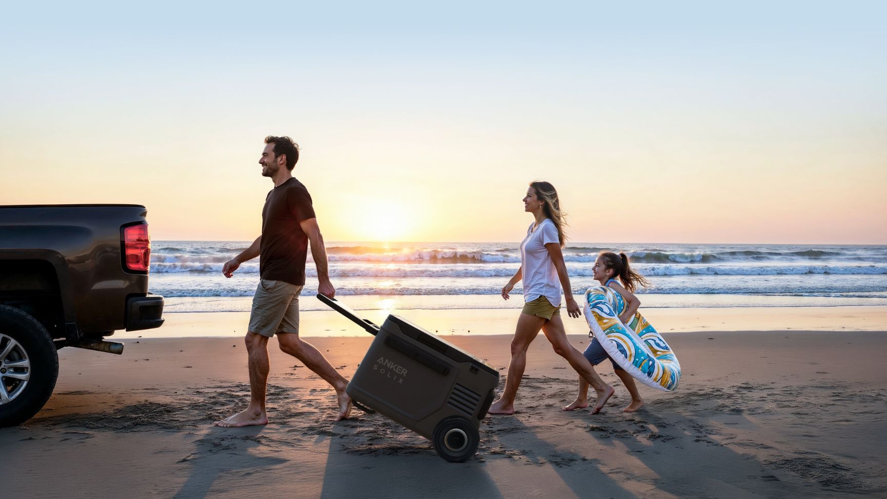 Man pulling the Anker SOLIX EverFrost 2 Electric Cooler 40L on a trolley beside the beach with two others