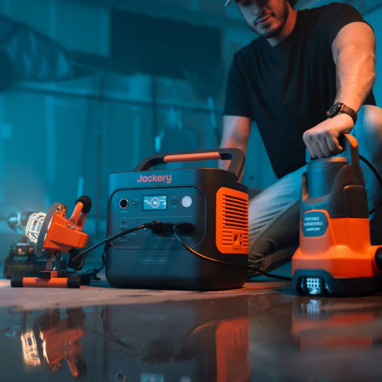 Man using Jackery Explorer 2000 v2 Portable Power Station with a connected machine outdoors